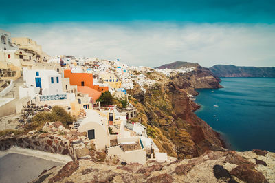 High angle view of townscape by sea against sky