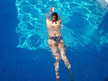 High angle view of child swimming in pool