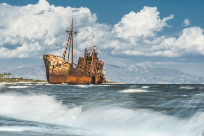 Sailboat in sea against sky