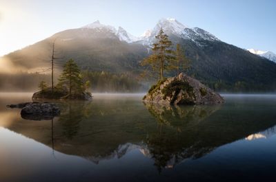 Scenic view of lake and mountains against sky