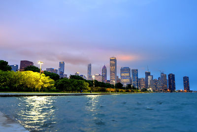 River and buildings against sky in city