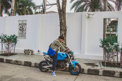 Man riding bicycle by building