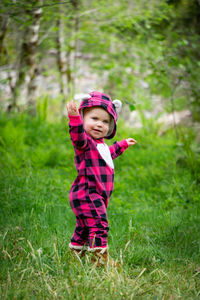 Portrait of cute girl standing on grass