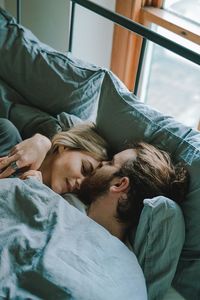Young couple relaxing on bed at home