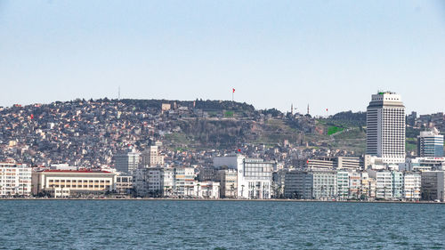 Buildings in city against clear sky