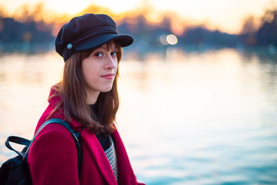 Portrait of beautiful woman in lake during sunset