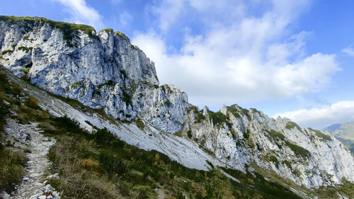 Low angle view of snowcapped mountains against sky