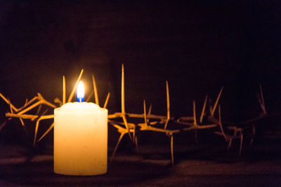 Close-up of lit candles in the dark