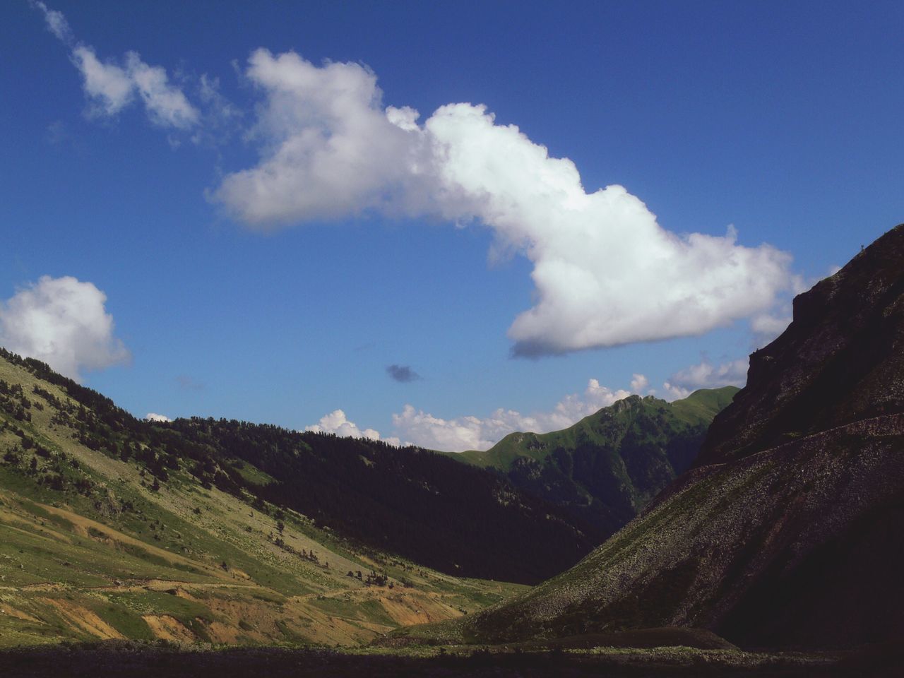 sky, tranquil scene, tranquility, mountain, scenics, landscape, beauty in nature, blue, nature, cloud, cloud - sky, mountain range, non-urban scene, remote, idyllic, day, outdoors, hill, horizon over land, sunlight