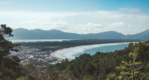 Scenic view of sea and mountains against sky