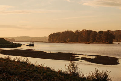 View of calm lake at sunset