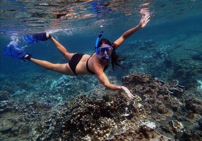 Woman scuba diving in sea