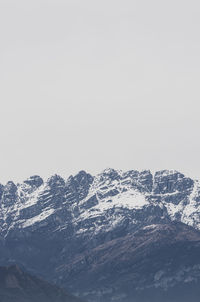 Scenic view of snowcapped mountains against clear sky