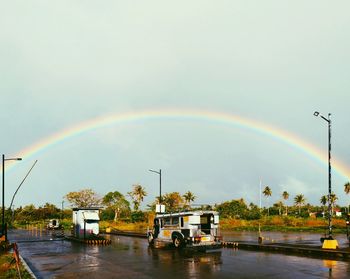 Rainbow over trees against sky