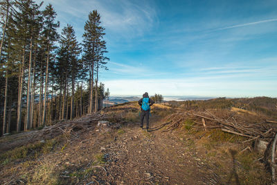 Traveller with a blue backpack on his back walks towards his unforgettable experiences in beskydy 