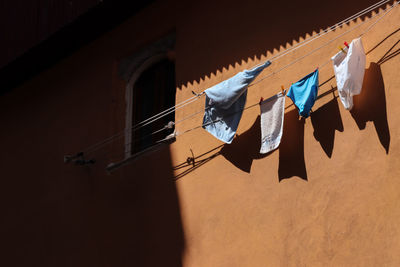 Low angle view of clothes drying against building