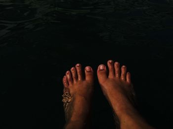 Low section of woman legs in water