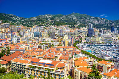 High angle view of buildings against blue sky