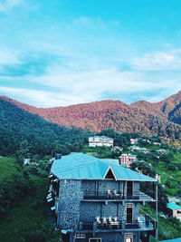 Houses on mountain against sky