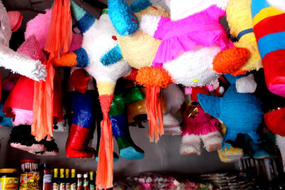 Low angle view of stuffed toys hanging at market stall