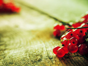 Close-up of red currants on wooden table