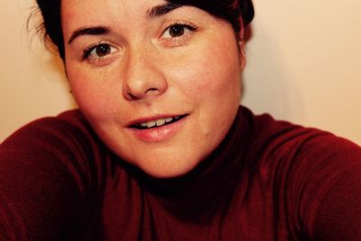 Close-up portrait of smiling young woman