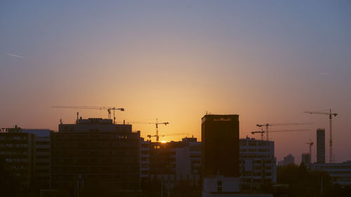 Exterior of silhouette buildings against sky during sunset