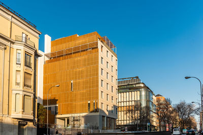 Low angle view of buildings against clear blue sky