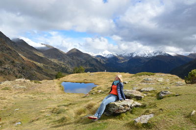 Blond girl is dreaming in the mountains