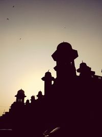 Low angle view of silhouette building against sky during sunset