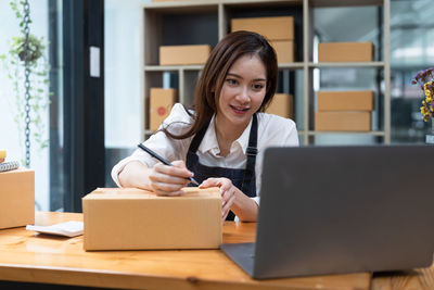 Young woman using laptop at office
