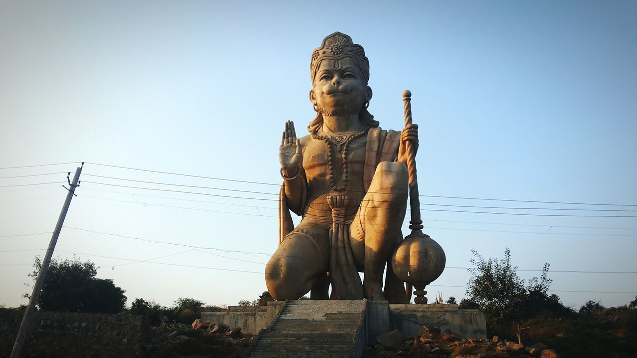 statue, religion, human representation, sculpture, sky, idol, low angle view, place of worship, outdoors, no people, architecture, day