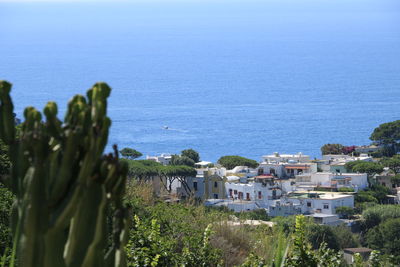 High angle view of buildings by sea against sky