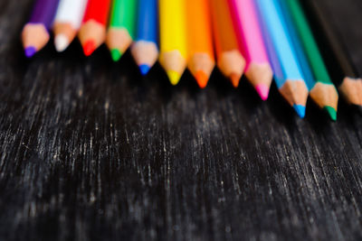 Close-up of multi colored pencils on table