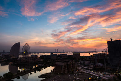 High angle view of buildings against cloudy sky during sunset