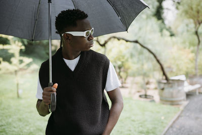 Young woman holding umbrella