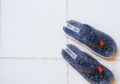 Close-up of shoes on tiled floor