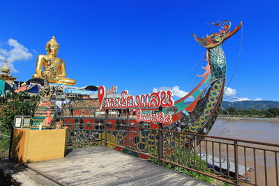 Close-up of sculpture against blue sky