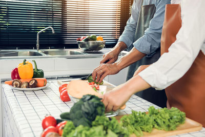 Midsection of man preparing food at home