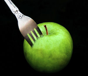 Close-up of apple against black background