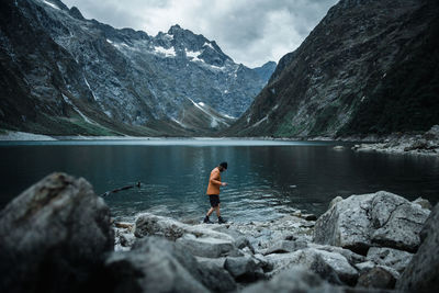 Scenic view of lake by mountains against sky