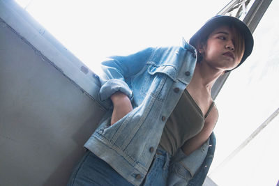 Low angle view of man sitting against sky