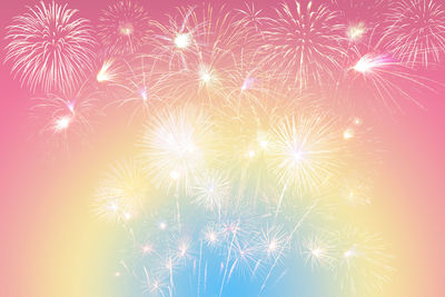 Low angle view of firework display at night