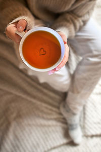 Conceptual take your time girl holding a cup of tea