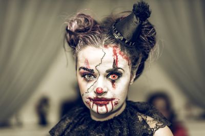 Close-up portrait of young woman with spooky halloween make-up