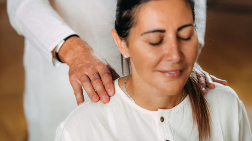 Woman enjoying shiatsu neck and shoulders massage.