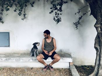 Full length of young woman with dog