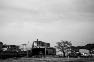 Street by buildings against sky