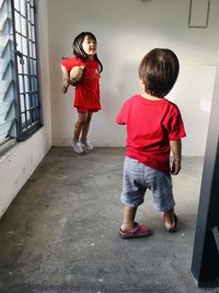 Rear view of friends standing in corridor
