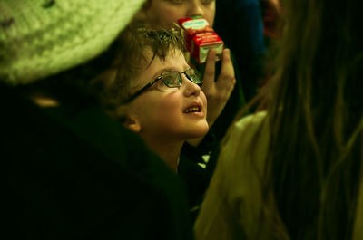 Close-up of cute boy looking away in darkroom